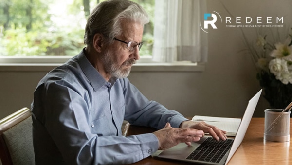 Senior man retiree wearing glasses working browsing news on laptop