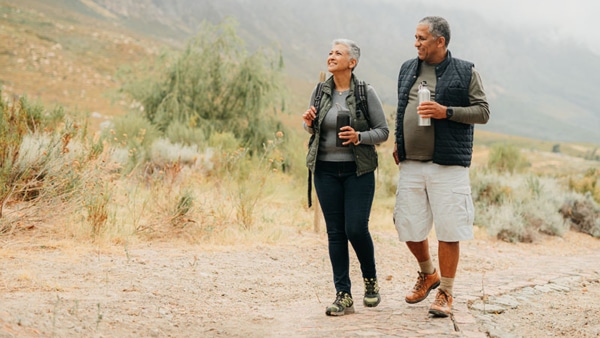 Nature, health and a couple hiking an adventure trail during retirement. 