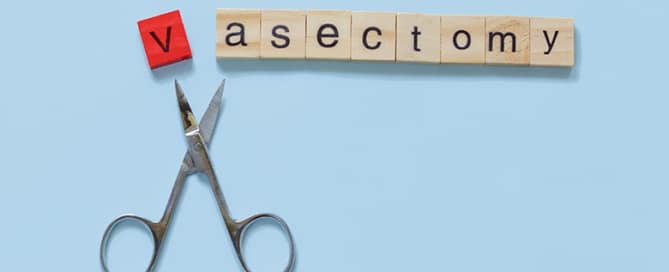 scrabble letters spelling out "Vasectomy" with scissors snipping off the letter V.